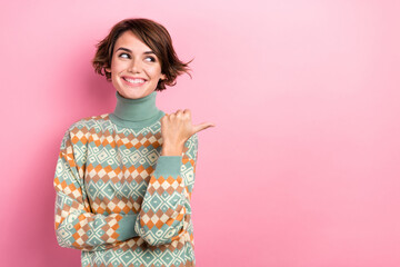 Photo of positive gorgeous girl beaming smile look indicate thumb finger empty space isolated on pink color background