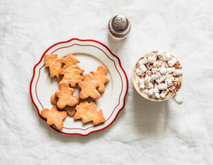 Hot chocolate with marshmallows and Christmas shortbread cookies on a light background, top view