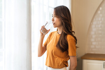 Portrait asian beauty body slim woman drinking water from a glass while relax and feeling fresh, ...