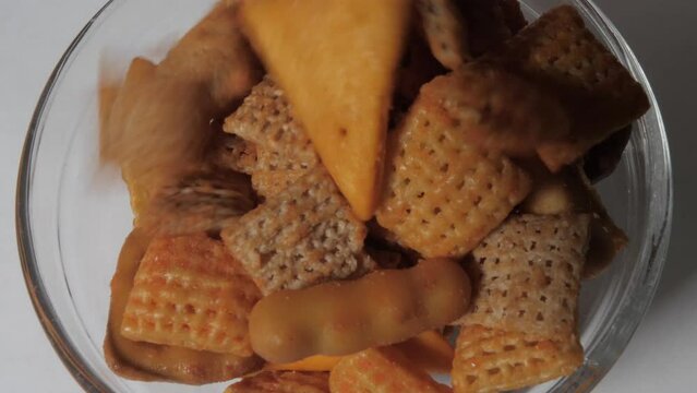 Chex Mix being poured into a bowl