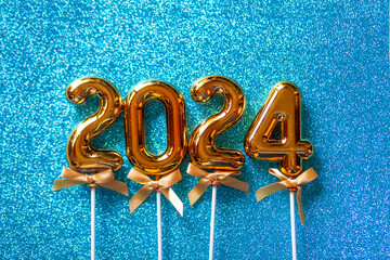  2024 New Year numbers Concept - Orange old gold numbers on light blue glitter background