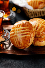 Traditional turkish breakfast buns ( pogaca ) served with black turkish tea.