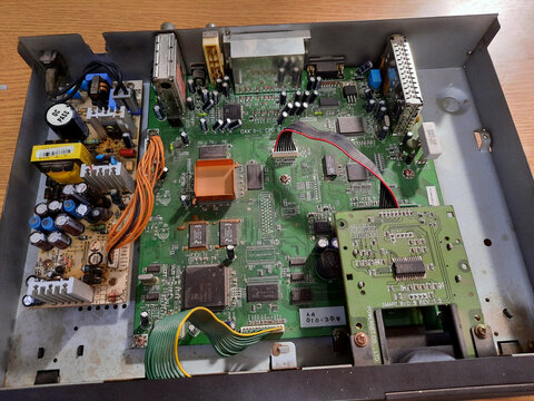 Cairo, Egypt, October 15 2023: Interior of an old satellite receiver device Humax IRCI-5400Z, with electronic chips, condensers, circuits, ICs and wires, with Intel, Phillips electronic components
