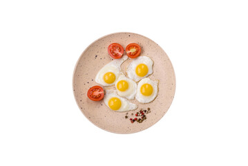 Delicious nutritious breakfast of fried quail eggs, bacon, legumes and cherry tomatoes