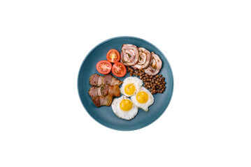 Delicious nutritious breakfast of fried quail eggs, bacon, legumes and cherry tomatoes