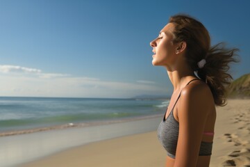 Fototapeta na wymiar Woman inhaling deeply at the beach
