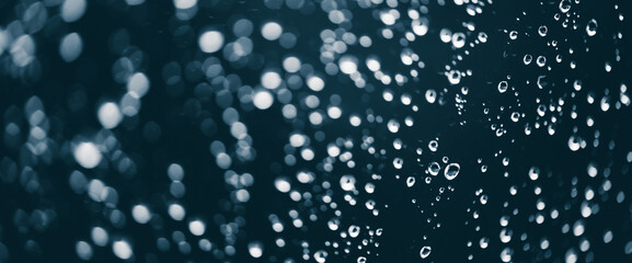 Atmospheric minimal monochrome backdrop with rain droplets on glass. Wet window with rainy drops...