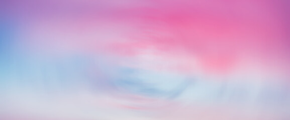 Beautiful backdrop of sunset sky with pink orange light clouds in blue sky. Colorful smooth dawn...