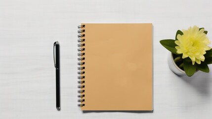 Blank notebook with pen and decorative plant on white background