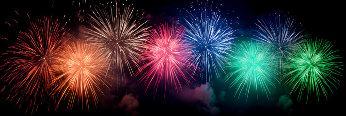 Colourful multi colored fireworks on black background during New Year or Christmas party or any celebration event outdoor
