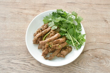 fried slice pork meat with garlic couple pepper topping parsley on plate  