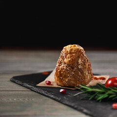 Dough dish with meat sprinkled with sesame seeds