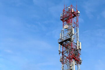 5g tower mast with radio modules on a city skyline, providing telecommunication services with 4g and 5g cellular networks and macro base stations.