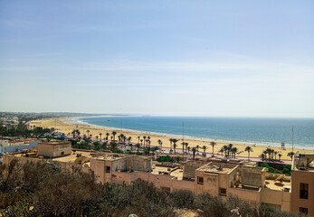 Obraz premium Natural view of Agadir city and nice beach on sunny day with beautiful sky. Moroccan atlantic ocean.
