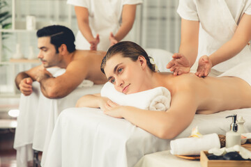 Caucasian couple customer enjoying relaxing anti-stress spa massage and pampering with beauty skin...