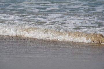 Mediterranean seashore in winter. Calm sea waves on sandy beach.