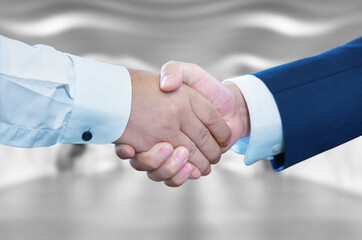 Business handshake on bright background, Two businessman shake hand with partner to celebration...