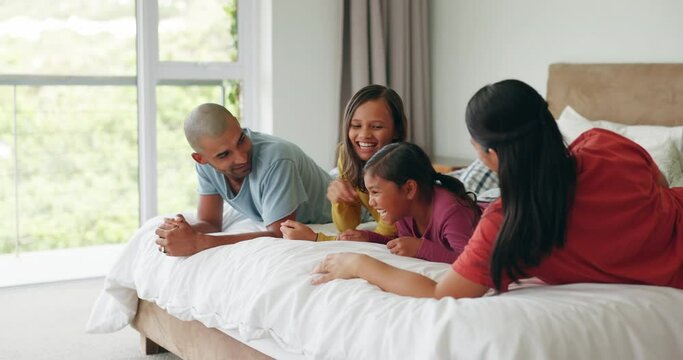 Bed, morning fun and happy family relax, bonding or enjoy quality time together, vacation holiday and kids play games. Malaysia, excited energy and home mom, dad and children jump on bedroom mattress