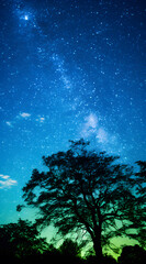 Fototapeta na wymiar A night sky filled with stars and clouds