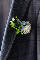 Boutonniere flower on the groom's jacket
