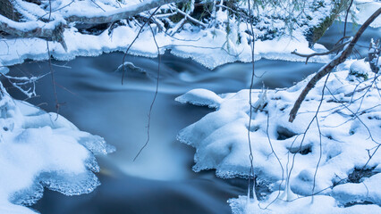 Natural stream with fresh snow