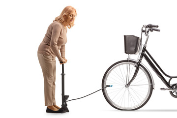 Woman using a manual pump for a flat bicycle tire