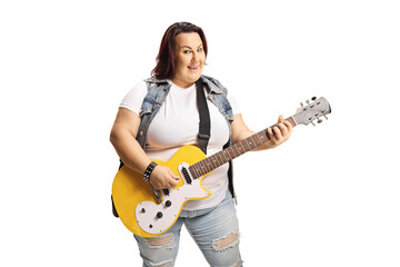 Young female playing an electric guitar and smiling