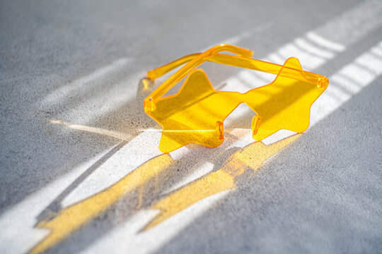 Close-up of a pair of yellow star shaped novelty glasses on a table