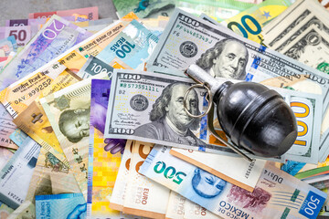 Currencies from around the world and hand grenade lying on them, Financial concept, Threats to the currency market, Effects of war, Financial sector
