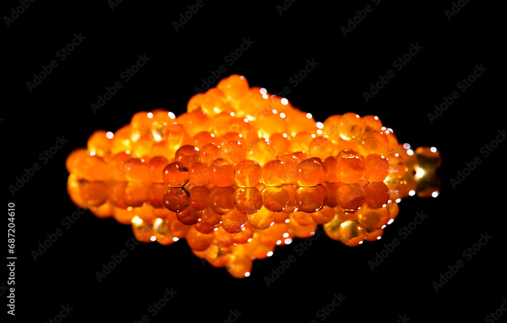 Wall mural red caviar close up. salmon caviar isolated on black background. delicious gourmet food. delicatesse