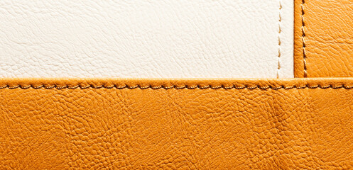 Leather or leatherette background is half white and red. Panorama.