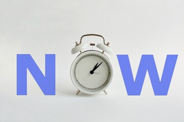  Alarm clock on a white background and the word NOW. The concept of motivation to start acting now, without delaying until later, choosing a goal, business planning, and planning for money growth.