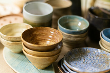 stacks of sets of glazed ceramic bowls
