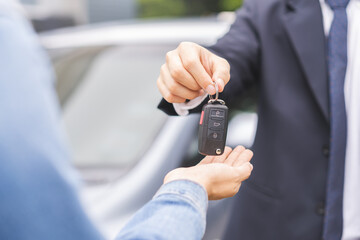 Business car rental, sell or buy service, dealership hand of agent dealer, sale man giving auto key...