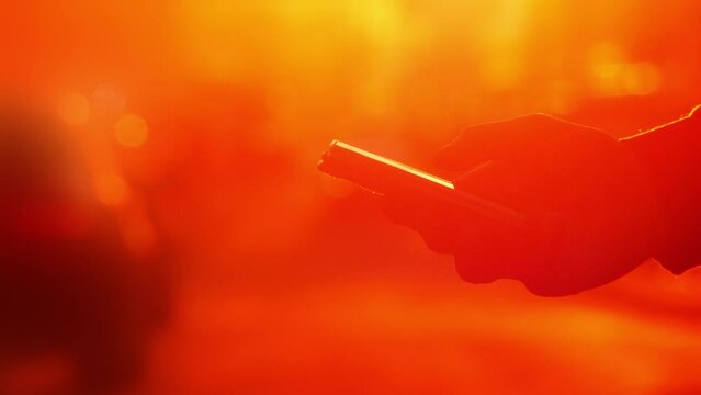 Close up hand using smartphone car online ordering taxi app mobile network traffic road car abstract road background traffic blur. Using mobile phone road sunset. Booking taxi. Ride share. Car sharing
