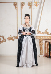 Young serious beautiful woman in rococo style medieval dress
