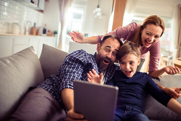 Happy family enjoying time together on the sofa at home