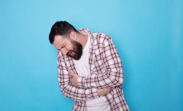 Man with abdominal pain health problem discomfort diarhea blue background. 