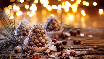 Chocolate pine cones, dusted with powdered sugar, close-up. Idea for  Christmas dessert