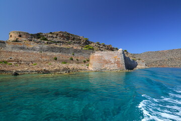 Fototapeta premium Spinalonga Island on a Beautiful sunny day showing the turqoius sea and blue sky. Crete, Greece, Europe.