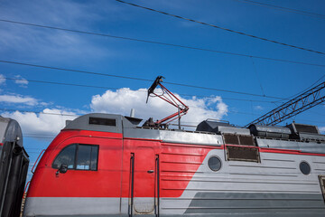 electric train on an early sunny day against a blue sky