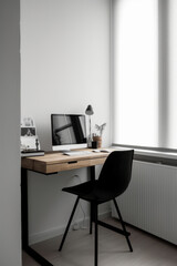 Minimalistic home office interior with clean design, a sleek desk, ergonomic chair, and organized workspace. The simplicity creates focused and aesthetically pleasing environment for productive work.