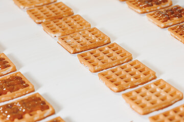 Robotic Manufacturing conveyor production line Belgian waffles. Automatic bakery plant food factory