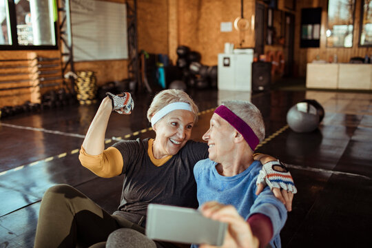 Active Senior Couple Taking Selfie in Gym - Powered by Adobe