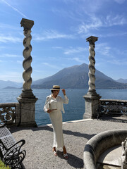 beautiful woman with dark hair in elegant clothes posing in luxurious villa at Como lake in Italy