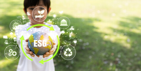 Focused planet Earth globe with eco friendly icon hold by blur little boy, symbolize environmental...