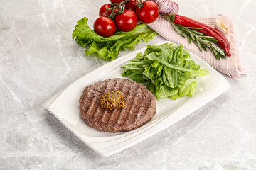 Frilled beef burger cutlet with iceberg