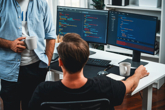 IT developers discussing online software development information on pc screen, creating program coding for latest version application on website. Concept of brainstorming firmware updated. Sellable.