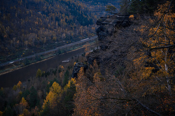 Great view to the amazingly deep valleys and dark forests with stormy clouds overhead in the...