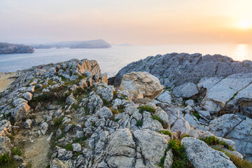 Fototapeta na wymiar Sunset over the Santander Bay. Island of Virgen del Mar, Cantabria, Spain.